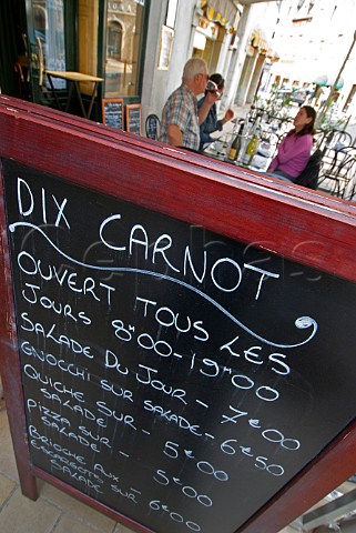 Menu blackboard with alfresco diners at the Dix   Carnot restaurant Beaune  Cte dOr Burgundy France