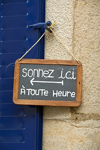Small blackboard sign outside wine tasting cave   ring here anytime  Cte dOr France