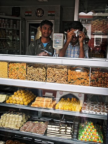 Young Indian men behind counter of shop selling   sweets and savouries   Chennai Madras India