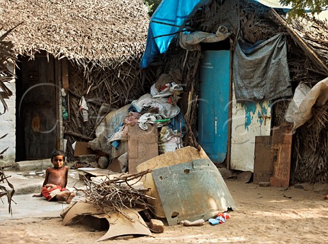 Young boy sitting outside shanty dwelling Chennai   Madras India