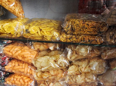 Packets of savouries for sale Chennai Madras   India  Banana crisps Bombay mix cheese puffs and   crisps