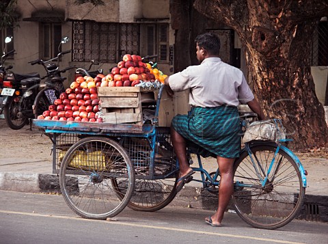 Indian man selling fruit from tricycle Chennai   Madras India