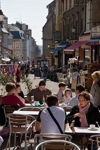 Terrace tables outside the many cafs and   restaurants on Rue de Lille in the old quarter of   Boulogne PasdeCalais France