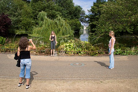 Tourists photographing each other in St Jamess Park London
