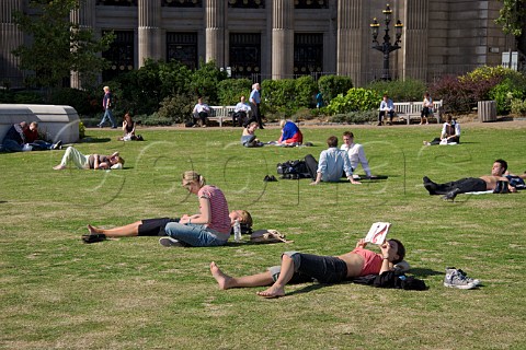 Office workers relaxing at lunchtime in small square   by Trinity House London