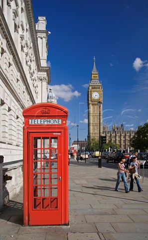 Red telephone box in Parliament Square with Big Ben   and the Houses of Parliament in the distance London
