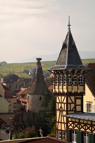 Halftimbered tower of Domaine Trimbach with a   tower of the medieval town fortifications beyond    Ribeauvill HautRhin France  Alsace