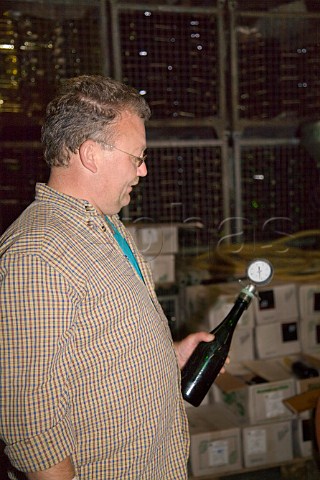 Checking the pressure gauge on a test bottle of sekt   at Weingut Johann Mertes Erden Germany   Mosel