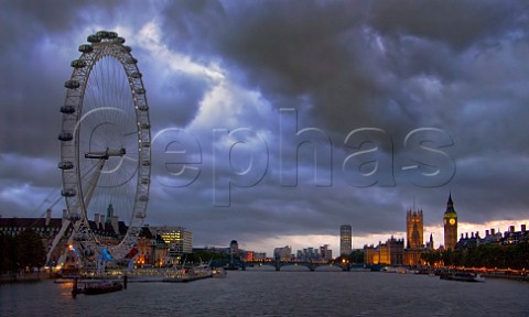 London Eye with the Houses of Parliament and the River Thames at dusk London