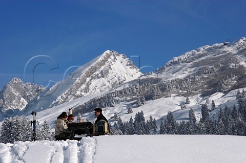 Skiers have lunch by the Col des Annes below the Pointe dAreu 2478m in the Chaine des Aravis Le GrandBornand HauteSavoie France