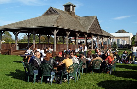 Tourists enjoying wine with lunch on Columbus Day in garden of Pindar Vineyards Peconic Long Island New York USA North Fork AVA