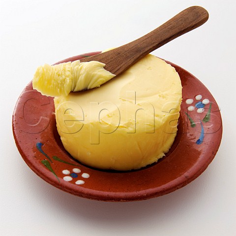 A pat of butter with a knife on top