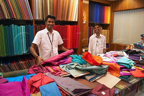 Men behind the silk counter in Pothys textile store Panagal Park Chennai Madras Tamil Nadu India