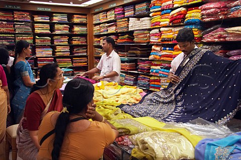 Women looking at sarees inside Pothys textile store Panagal Park Chennai MadrasTamil Nadu India
