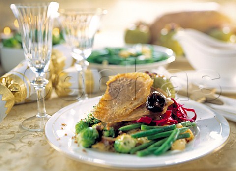 A plate of roast goose and vegetables