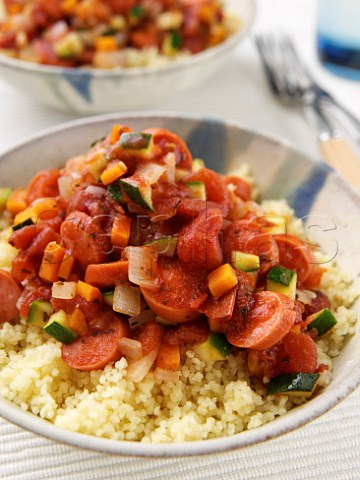 Sliced spicy sausage on couscous