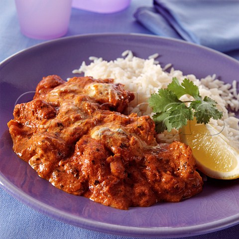 A plate of chicken tikka masala and rice