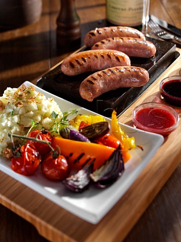 Grilled sausages and vegetables with mashed potato