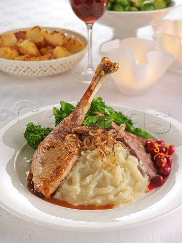 Plate of roast goose leg with jerusalem artichoke puree