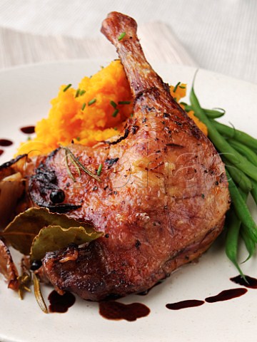Roast duck leg with mashed swede and green beans