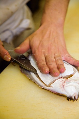 Filleting a plaice for sashimi in a Japanese restaurant