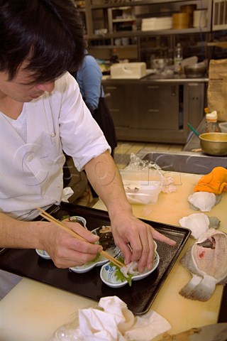 Preparing dab Sashimi in a Japanese restaurant