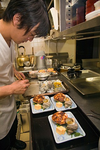 Preparing crab gratin with seashell and tofu in a Japanese restaurant