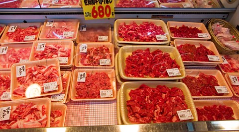 Thinly sliced beef on sale in a Japanese supermarket Australian lean red meat on the right Japanese paler marbled beef to the left