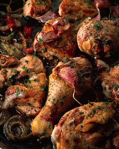Roast chicken pieces with onions and garlic