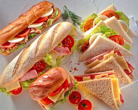 Assorted bread products with summer sandwich fillings