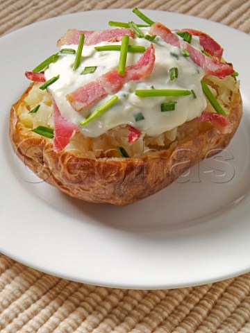 Jacket potato with cheese chive and bacon topping