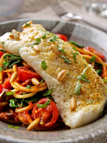 Baked cod with pinenuts and spaghetti