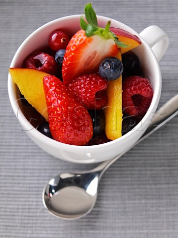 Fruit salad in a cup with a spoon