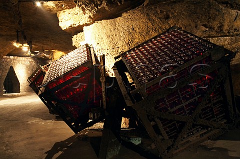 Bottles of sparkling ros wine in giropalettes in the cellars of BouvetLadubay which have been cut from the tuffeau subsoil  Saumur MaineetLoire France Crmant de Loire