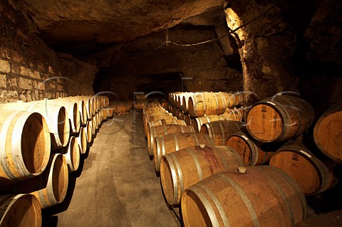 Barrels in the cellars of BouvetLadubay which have been cut from the tuffeau subsoil Saumur MaineetLoire France