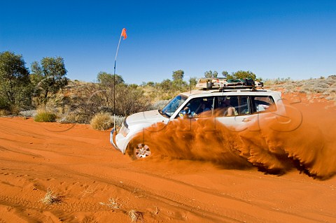 4WD car crossing red sand dune on the Canning Stock Route Western Australia