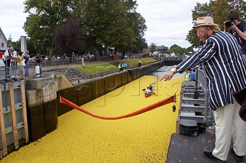 John McCririck points at the ducks as the Molesey lock gates open and the 165000 plastic ducks start the Great British Duck Race 2007 and set a new Guinness World Record River Thames near Hampton Court Surrey England
