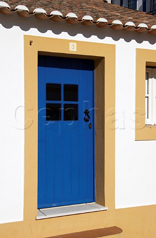 Blue painted door of traditional style house at Vila Nova de Milfontes Odemira Portugal