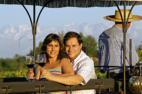 Couple drinking wine on a horse and carriage tourist ride at Viu Manent with the Andes mountains in the distance Colchagua Valley Chile Rapel