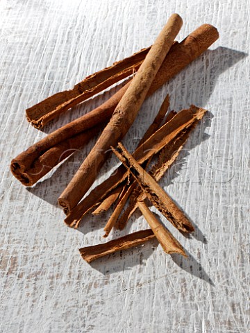 Cinnamon sticks on a rough white background
