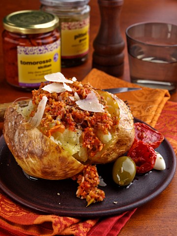 Jacket potato with tomato and garlic filling topped with parmesan flakes