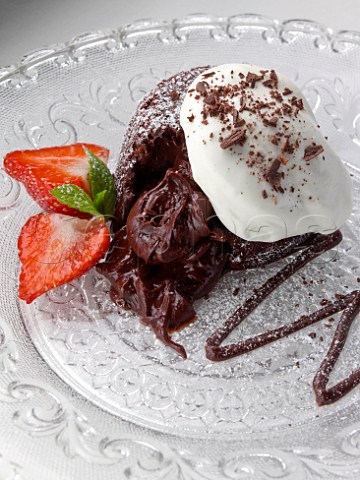 Chocolate fondant pudding with strawberries and cream