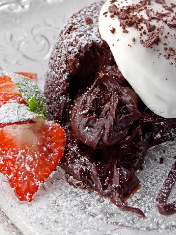 Chocolate fondant pudding with strawberries and cream