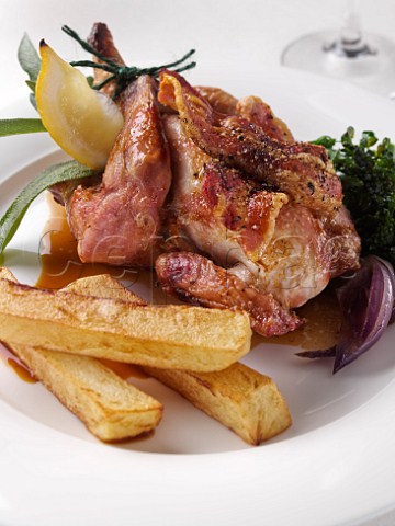 Whole roast poussin with streaky bacon and French fried potato chips
