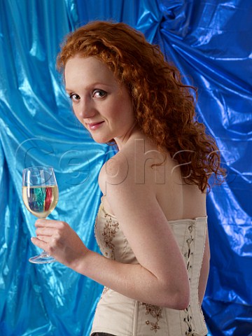 Young woman holding a glass of white wine