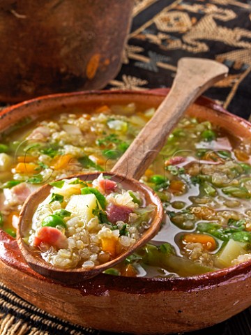 Bowl of quinoa soup with spoon