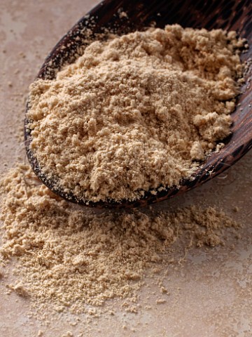 Ginger powder in wooden spoon