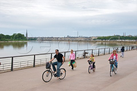 Family cycling on the promenade by the Garonne river Bordeaux Gironde France
