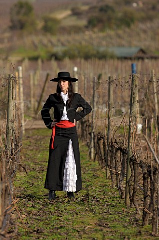 Girl dressed in traditional Chilean huasa clothes in the Clos Apalta vineyard of Lapostolle Colchagua Valley Chile