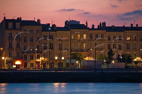 Lights of Quai des Chartrons reflecting in the Garonne river at dusk Bordeaux Gironde France